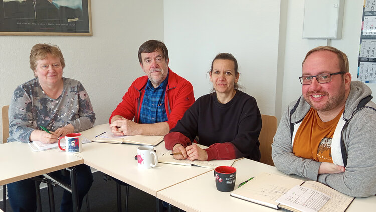 Projekt „HOGA-Resilienz“ im Arbeitsgespräch mit dem  DEHOGA Sachsen-Anhalt e.V. An einem Tisch sitzen zwei Frauen und ein Mann, die auf dem Tisch ein Notizbuch liegen haben.