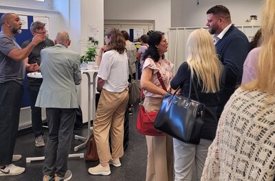 Austausch Die Teilnehmenden des Reinickendorfer Ausbildungsdialogs tauschen sich rege aus, an Stehtischen.